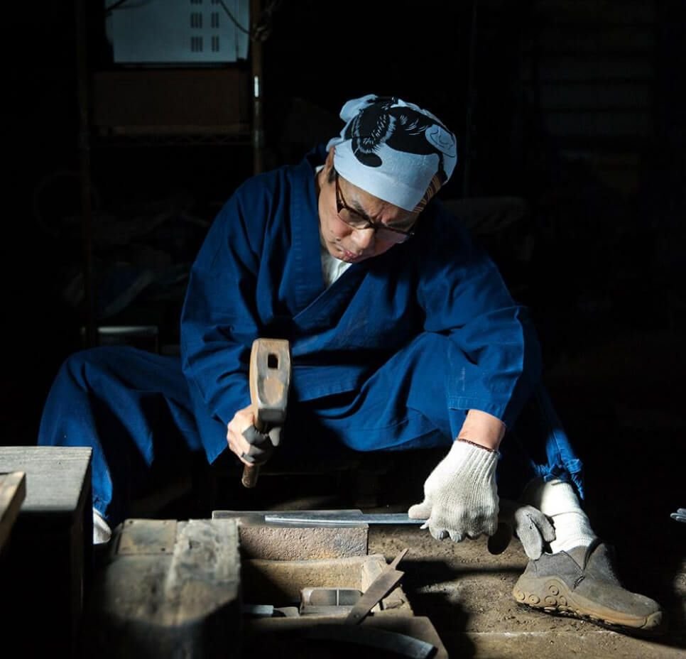 Japanese craftsman forging a knife blade by hand